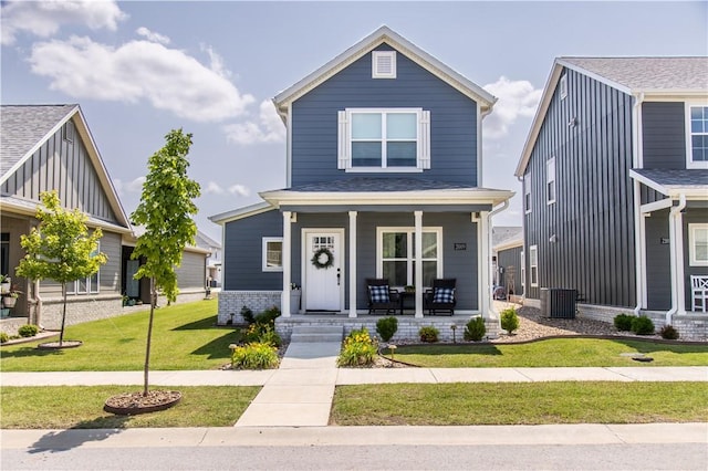 2009 Poppy St, Bentonville, AR 72713 - view of front of property with a porch, a front lawn, and central AC