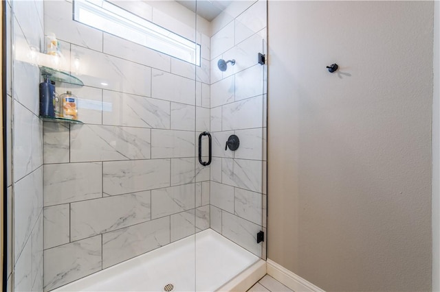 2009 Poppy St, Bentonville, AR 72713 - bathroom with a shower stall and baseboards