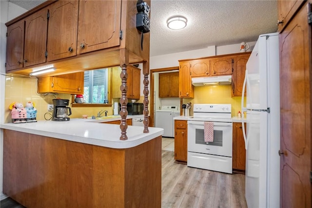5 Chapel Ln, Bella Vista, AR 72715 - kitchen featuring white appliances, under cabinet range hood, a peninsula, brown cabinetry, and a textured ceiling