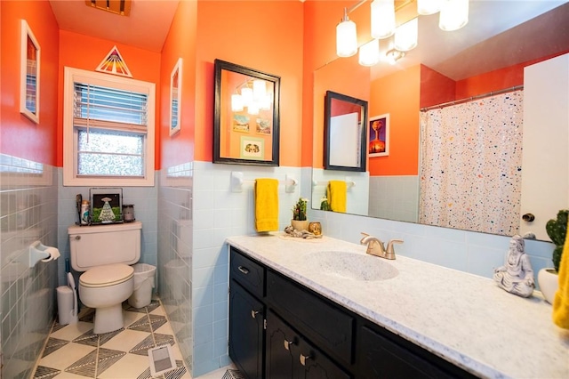 5 Chapel Ln, Bella Vista, AR 72715 - full bathroom with tile walls, vanity, toilet, a wainscoted wall, and tile patterned floors
