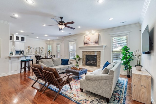 5203 SW Newcastle Rd, Bentonville, AR 72713 - living area featuring ceiling fan, crown molding, wood finished floors, a high end fireplace, and recessed lighting