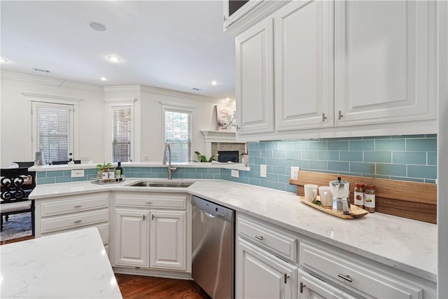 5203 SW Newcastle Rd, Bentonville, AR 72713 - kitchen featuring stainless steel dishwasher, a sink, crown molding, white cabinetry, and a fireplace