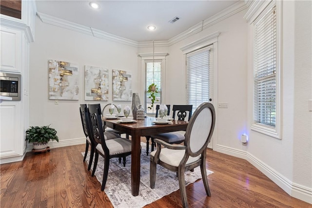 5203 SW Newcastle Rd, Bentonville, AR 72713 - dining space featuring dark wood-style flooring, baseboards, ornamental molding, and recessed lighting