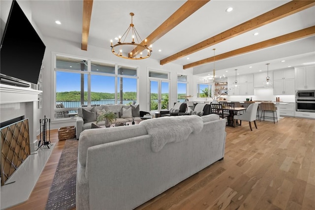 10393 Cedar Rock Rd, Garfield, AR 72732 - living area with a chandelier, beamed ceiling, recessed lighting, light wood-type flooring, and a fireplace