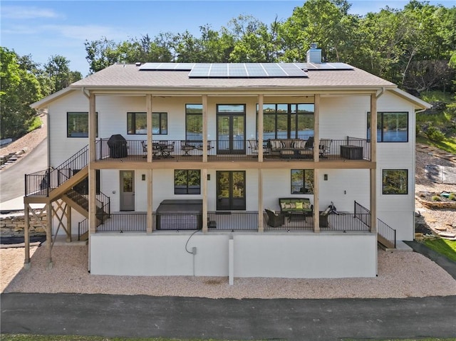 10393 Cedar Rock Rd, Garfield, AR 72732 - back of house with a balcony, stairway, solar panels, and a chimney
