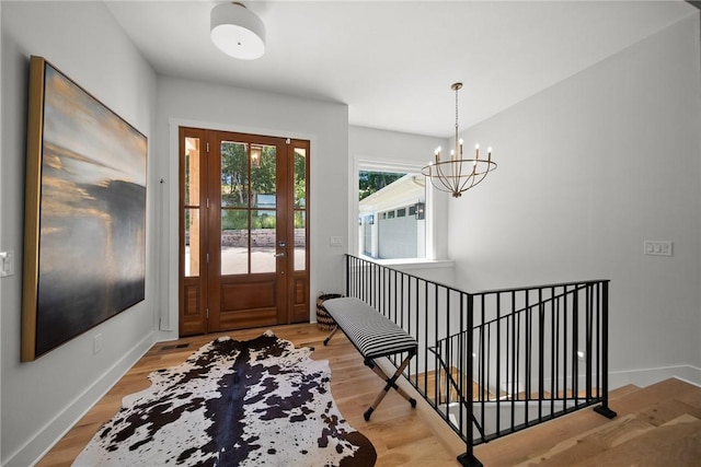10393 Cedar Rock Rd, Garfield, AR 72732 - entryway with light wood-style floors, a chandelier, and baseboards