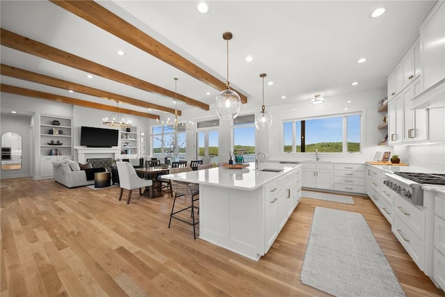 10393 Cedar Rock Rd, Garfield, AR 72732 - kitchen with gas cooktop, a spacious island, white cabinets, open floor plan, and light countertops