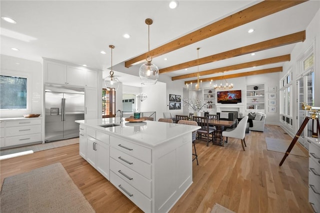 10393 Cedar Rock Rd, Garfield, AR 72732 - kitchen featuring stainless steel built in refrigerator, a sink, recessed lighting, healthy amount of natural light, and beam ceiling