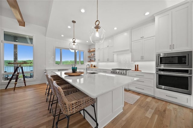 10393 Cedar Rock Rd, Garfield, AR 72732 - kitchen with stainless steel appliances, a sink, a kitchen bar, light countertops, and recessed lighting