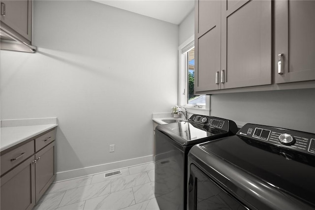 10393 Cedar Rock Rd, Garfield, AR 72732 - laundry area featuring separate washer and dryer, light marble finish flooring, cabinet space, and baseboards
