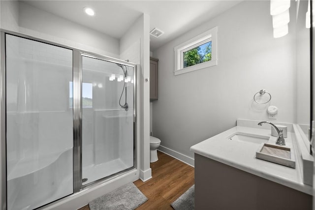 10393 Cedar Rock Rd, Garfield, AR 72732 - bathroom featuring toilet, vanity, a stall shower, baseboards, and recessed lighting