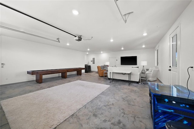 10393 Cedar Rock Rd, Garfield, AR 72732 - recreation room featuring unfinished concrete flooring, a garage, recessed lighting, and electric panel