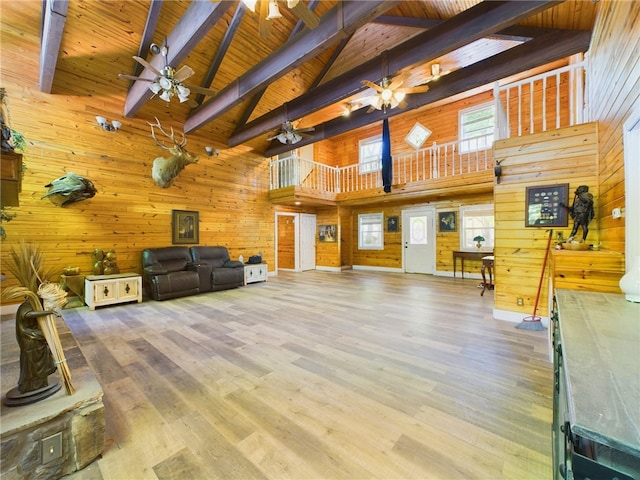 12883 Nickels Rd, West Fork, AR 72774 - living room with high vaulted ceiling, wooden walls, ceiling fan, wooden ceiling with exposed beams, and wood finished floors
