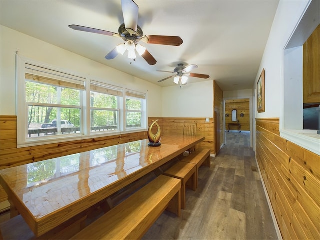 12883 Nickels Rd, West Fork, AR 72774 - dining area featuring wainscoting, wood walls, wood finished floors, and ceiling fan