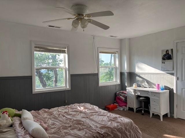 12883 Nickels Rd, West Fork, AR 72774 - bedroom with wainscoting, carpet, wooden walls, and a ceiling fan