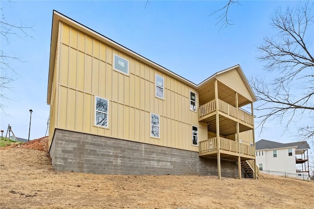2055 Collins Dr, Pea Ridge, AR 72751 - rear view of house featuring board and batten siding and a balcony