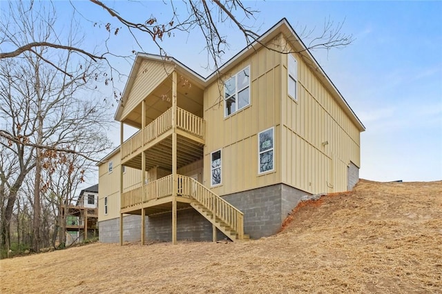 2055 Collins Dr, Pea Ridge, AR 72751 - back of property with a balcony, stairway, and board and batten siding