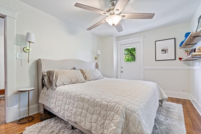 411 N Broadway St, Siloam Springs, AR 72761 - bedroom with wood finished floors, baseboards, and ceiling fan