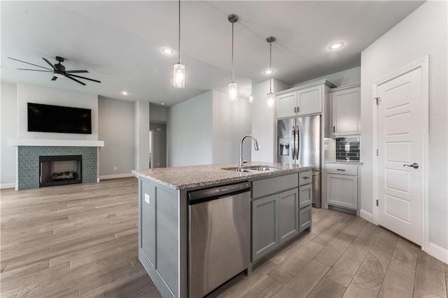483 N Otoe St, Farmington, AR 72730 - kitchen with stainless steel appliances, a sink, gray cabinetry, light wood-type flooring, and recessed lighting