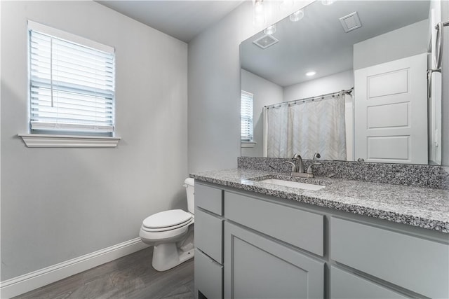 483 N Otoe St, Farmington, AR 72730 - full bath featuring vanity, baseboards, toilet, wood finished floors, and curtained shower
