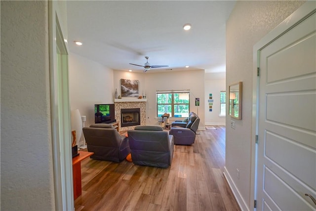 29 Bassingham Dr, Bella Vista, AR 72715 - living area featuring ceiling fan, wood finished floors, a fireplace, recessed lighting, and baseboards