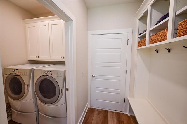 29 Bassingham Dr, Bella Vista, AR 72715 - washroom featuring washing machine and dryer, dark wood finished floors, cabinet space, and baseboards