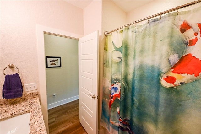 29 Bassingham Dr, Bella Vista, AR 72715 - bathroom with wood finished floors, baseboards, vanity, and a shower with shower curtain