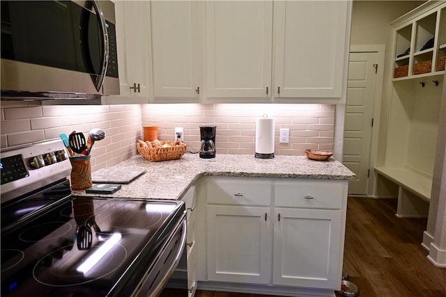 29 Bassingham Dr, Bella Vista, AR 72715 - kitchen featuring appliances with stainless steel finishes, dark wood-style floors, white cabinets, backsplash, and light stone countertops