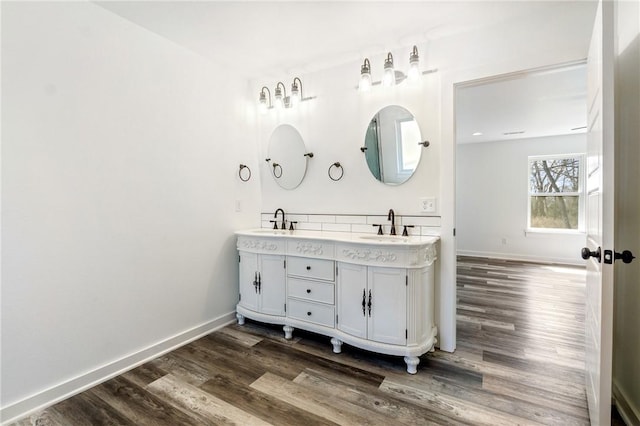 12698 Bush Rd, Centerton, AR 72719 - full bathroom with wood finished floors, double vanity, and baseboards
