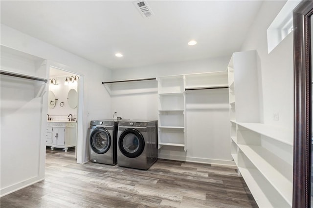 12698 Bush Rd, Centerton, AR 72719 - laundry area featuring washing machine and dryer, wood finished floors, and recessed lighting