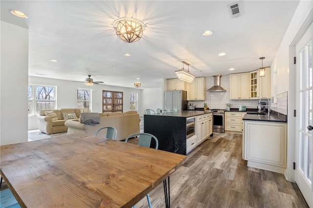 12698 Bush Rd, Centerton, AR 72719 - dining room featuring wood finished floors, a ceiling fan, and recessed lighting