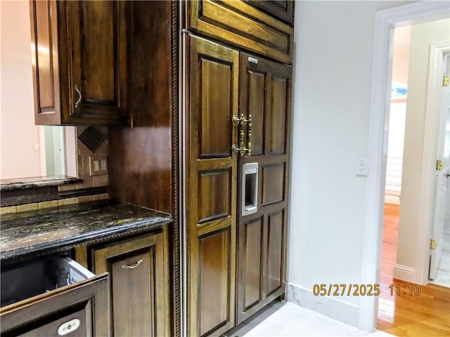 4007 Georgia St, Springdale, AR 72762 - kitchen with dark brown cabinetry, decorative backsplash, and light wood-type flooring