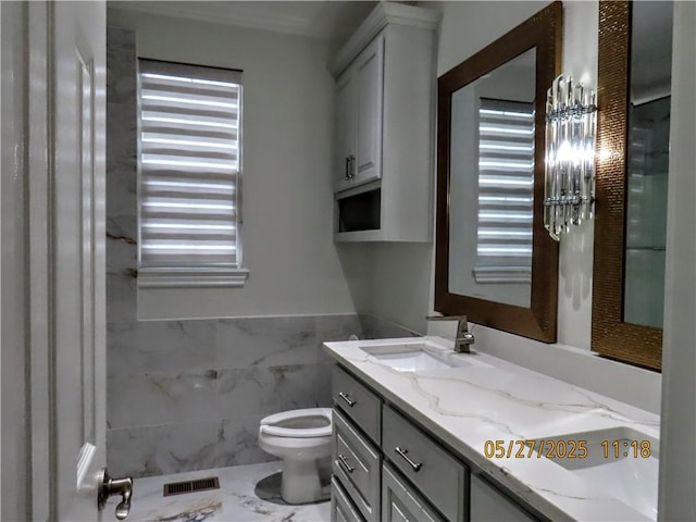 4007 Georgia St, Springdale, AR 72762 - bathroom with toilet, vanity, tile walls, and a wainscoted wall