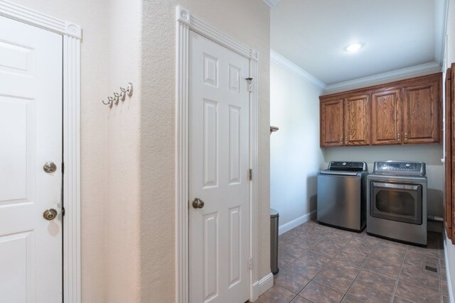 15210 Haynes Rd, Rogers, AR 72756 - laundry room with washing machine and clothes dryer, crown molding, cabinet space, baseboards, and dark tile patterned floors