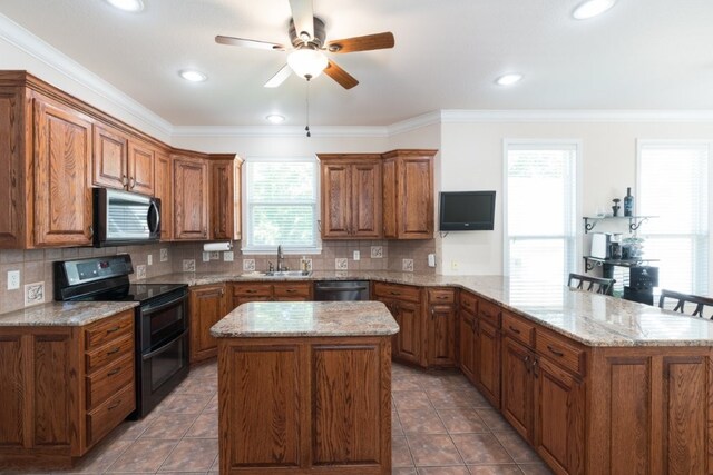 15210 Haynes Rd, Rogers, AR 72756 - kitchen featuring stainless steel appliances, a peninsula, brown cabinetry, a kitchen island, and crown molding