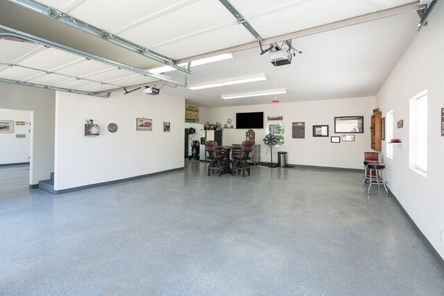 15210 Haynes Rd, Rogers, AR 72756 - garage featuring a garage door opener and baseboards