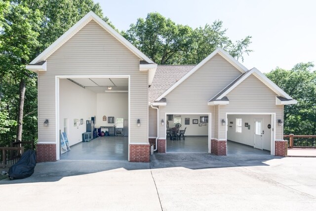 15210 Haynes Rd, Rogers, AR 72756 - view of front of house featuring concrete driveway, an attached garage, and brick siding