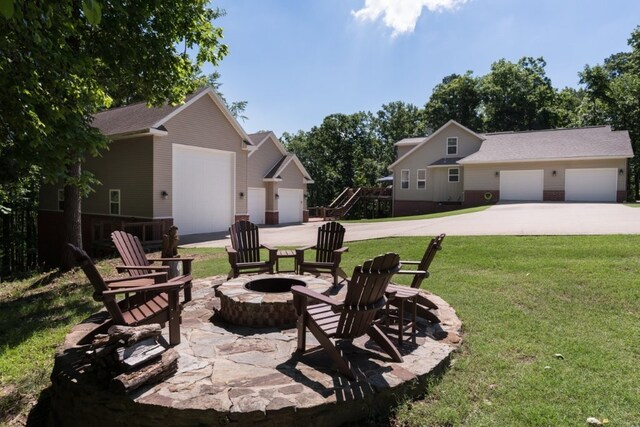 15210 Haynes Rd, Rogers, AR 72756 - view of green lawn with an outdoor fire pit and an outdoor structure