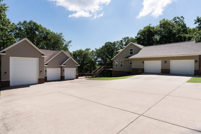 15210 Haynes Rd, Rogers, AR 72756 - view of side of home with brick siding, a shingled roof, and a garage