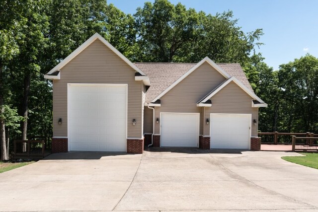 15210 Haynes Rd, Rogers, AR 72756 - view of front facade with brick siding, roof with shingles, concrete driveway, and a garage