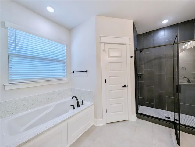 1 Darten Cir, Bella Vista, AR 72714 - bathroom with a garden tub, a stall shower, tile patterned flooring, recessed lighting, and baseboards