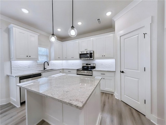 13 Epping Dr, Bella Vista, AR 72714 - kitchen featuring stainless steel appliances, light wood finished floors, white cabinetry, and recessed lighting