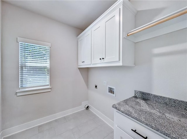 13 Epping Dr, Bella Vista, AR 72714 - laundry room with electric dryer hookup, baseboards, washer hookup, cabinet space, and light tile patterned flooring