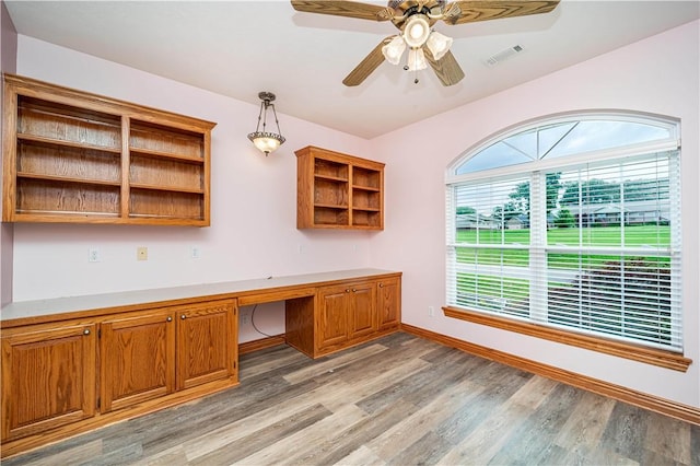 17 La Costa Dr, Holiday Island, AR 72631 - unfurnished office with built in desk, light wood finished floors, ceiling fan, and baseboards