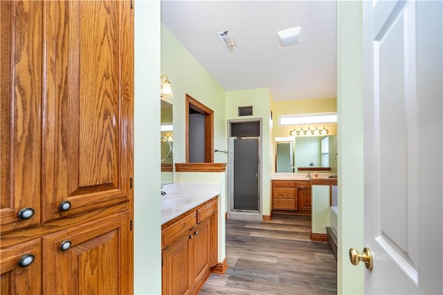 17 La Costa Dr, Holiday Island, AR 72631 - full bathroom featuring a stall shower, wood finished floors, and two vanities