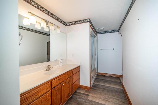 17 La Costa Dr, Holiday Island, AR 72631 - bathroom featuring vanity, wood finished floors, and baseboards
