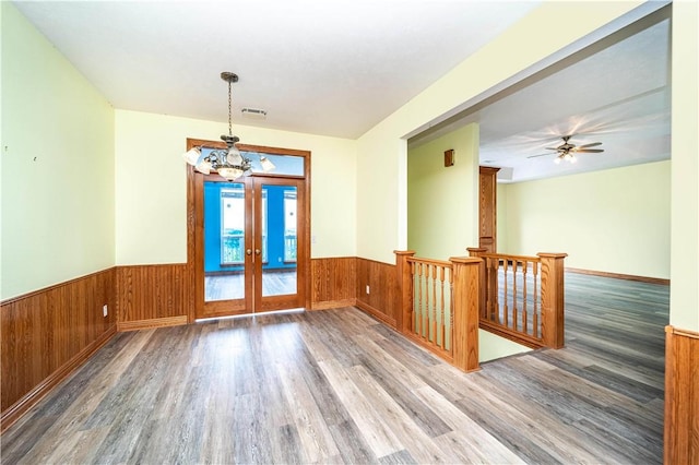 17 La Costa Dr, Holiday Island, AR 72631 - spare room with wood finished floors, wainscoting, a chandelier, french doors, and wooden walls