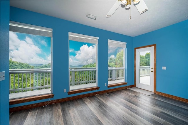 17 La Costa Dr, Holiday Island, AR 72631 - unfurnished room with wood finished floors, a ceiling fan, and baseboards