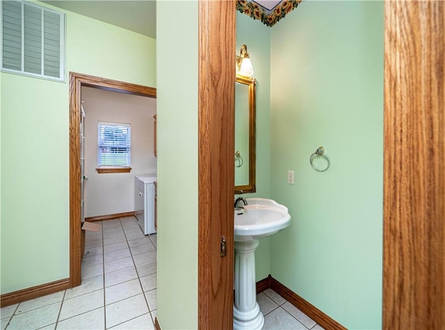 17 La Costa Dr, Holiday Island, AR 72631 - bathroom with separate washer and dryer, tile patterned flooring, and baseboards