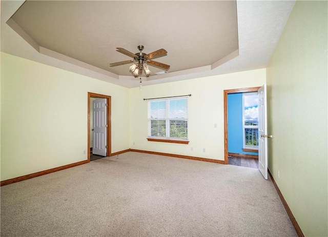 17 La Costa Dr, Holiday Island, AR 72631 - carpeted empty room with a tray ceiling, baseboards, and ceiling fan